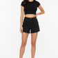Model wearing Black Denim Cutoff Shorts